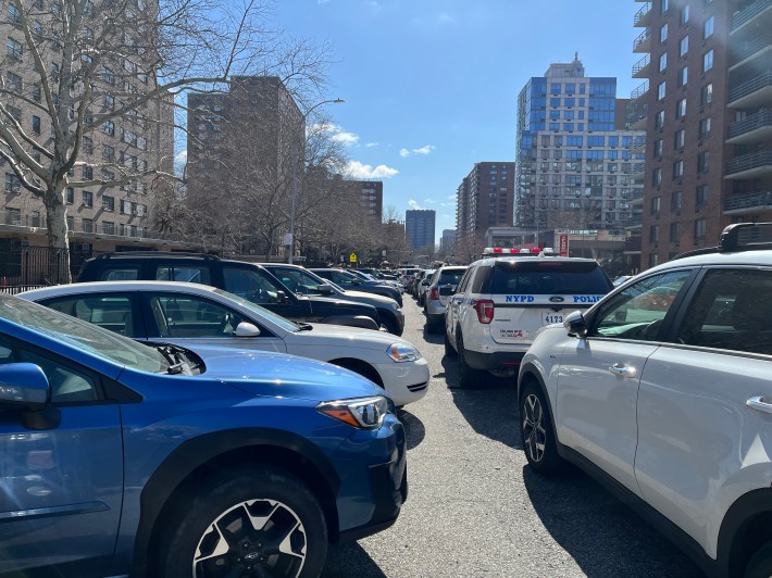 Police cars, both official and personal, double parked at the 24th. Both sides of the station house's block look like this.