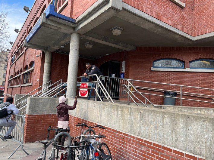 An officer manning the barricade at the totally blocked entrance of the 41st literally talks down to a resident.